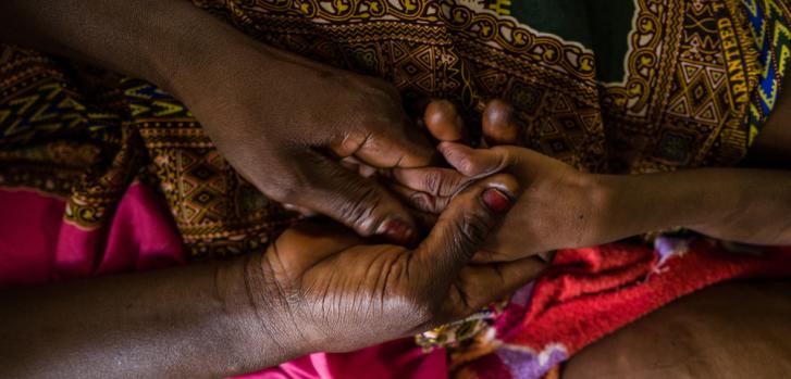 Una madre toma la mano de su hijo, admitido en el Hospital de Tukra (en Yamena, Chad) por un cuadro de malnutrición aguda con complicaciones médicas.Lys Arango.